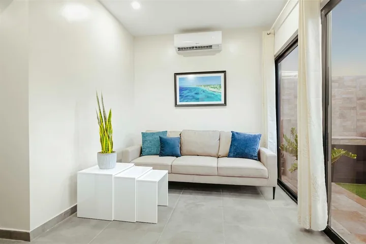 Bright sitting area with cream sofa in Sea La Vie Suite 1